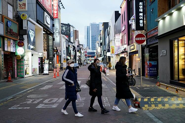 Women wearing masks to prevent contracting the coronavirus walk at Dongseong-ro shopping street in central Daegu, South Korea February 21, 2020. REUTERS/Kim Hong-Ji