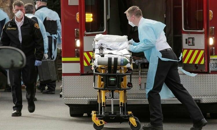 Nhân viên y tế di chuyển cáng để chuẩn bị đưa một bệnh nhân nhiễm nCoV lên xe cứu thương ở Kirkland, Washington, ngày 5/3. Ảnh: Reuters.